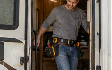 Illustrative scene of technician entering an RV with tools